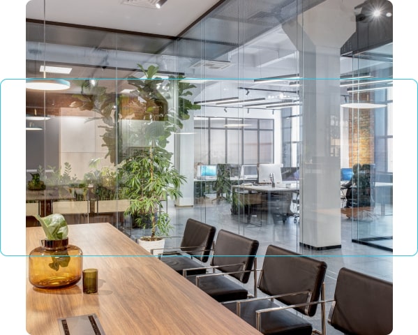 bright office space with desk, chairs and plants